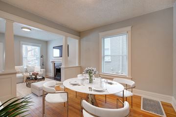 Denver apartment for rent - a dining room with a table and chairs and a living room