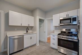 Denver apartment for rent - a kitchen with stainless steel appliances and white cabinets