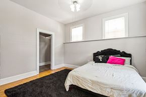 Chicago apartment for rent - A bedroom with a bed, pillow, and a rug.