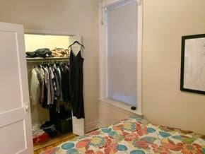 Chicago apartment for rent - A bedroom with a bed, a wardrobe, and a painting on the wall.