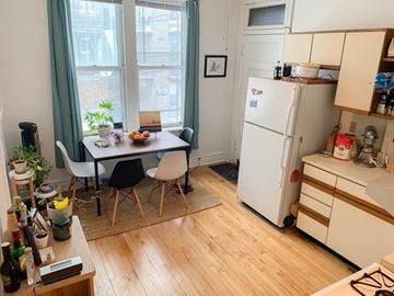 Chicago apartment for rent - A kitchen with a table and chairs in front of a window.