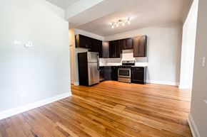 Chicago apartment for rent - A kitchen with wooden floors and white walls.