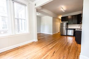Chicago apartment for rent - A kitchen with a refrigerator, stove, and cabinets.