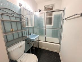 Chicago apartment for rent - A bathroom with a toilet, sink, and shower.