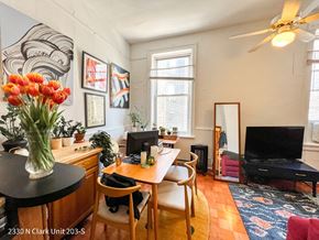 Chicago apartment for rent - A living room with a television, a desk, and a chair.