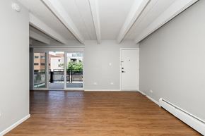 Denver apartment for rent - A room with wooden floors and white walls.