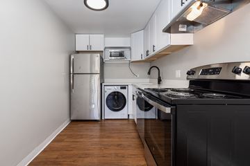Denver apartment for rent - A kitchen with a black counter and a stainless steel refrigerator.