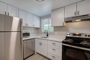 Denver apartment for rent - A kitchen with white cabinets and appliances.