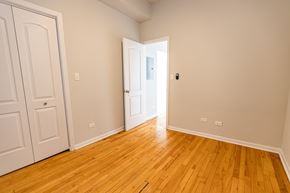 Chicago apartment for rent - A room with a white door and wooden flooring.