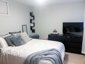 Chicago apartment for rent - A bedroom with a bed, a dresser, and a TV.