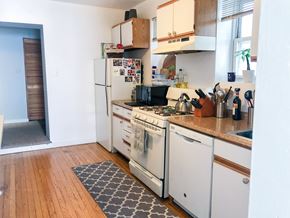 Chicago apartment for rent - A kitchen with a white fridge and white oven.