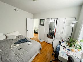 Chicago apartment for rent - A bedroom with a bed, desk, and chair.