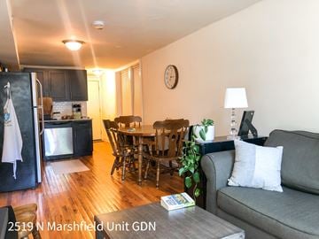 Chicago apartment for rent - A living room with a grey couch and a wooden coffee table.