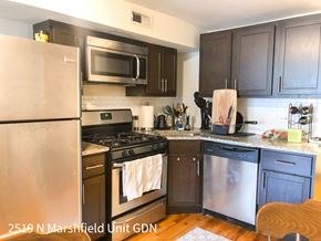 Chicago apartment for rent - A kitchen with a refrigerator, microwave, oven, and dishwasher.