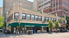 Chicago apartment for rent - A Starbucks Coffee shop is located in a building with a green awning.