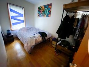 Chicago apartment for rent - A bedroom with a bed, a wardrobe, and a painting on the wall.