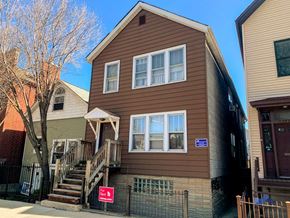 Chicago apartment for rent - a brown house with a red sign in front of it