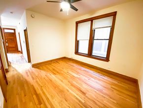 Chicago apartment for rent - A room with wooden flooring and a window.
