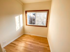 Chicago apartment for rent - A room with a window and wooden flooring.