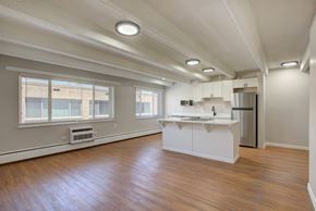 Denver apartment for rent - A kitchen with white cabinets and a wooden floor.