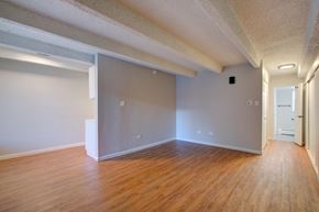 Denver apartment for rent - A room with wooden floors and white walls.