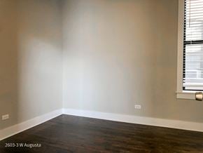 Chicago apartment for rent - A room with a window and wooden floors.