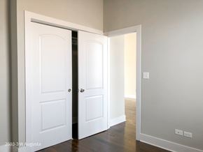 Chicago apartment for rent - A white door is open to reveal a room with a wooden floor.