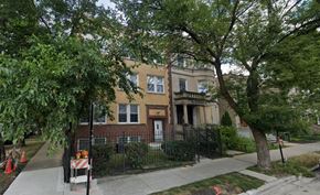 Chicago apartment for rent - A tree is in front of a two-story house.