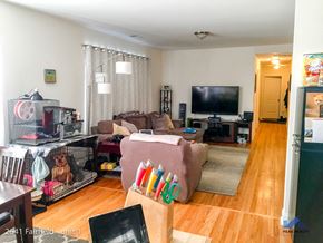 Chicago apartment for rent - A living room with a couch, chair, and television.
