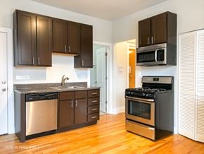 Chicago apartment for rent - A kitchen with dark brown cabinets and stainless steel appliances.