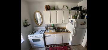 Chicago apartment for rent - A small kitchen with a white stove and white refrigerator.