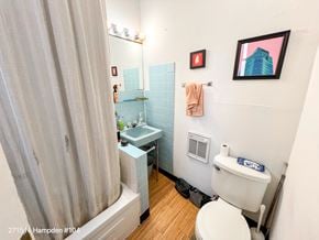 Chicago apartment for rent - A small bathroom with a toilet, sink, and shower.