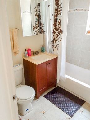 Chicago apartment for rent - A bathroom with a toilet, sink, and shower.