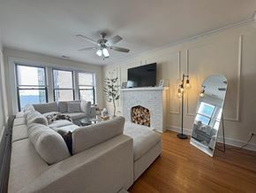 Chicago apartment for rent - A living room with a fireplace and a large couch.
