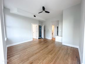 Chicago apartment for rent - A room with wooden flooring and a ceiling fan.