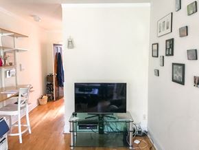 Chicago apartment for rent - A living room with a flat screen TV and a glass coffee table.