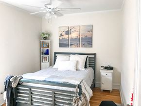 Chicago apartment for rent - A bedroom with a bed, nightstand, and a painting on the wall.
