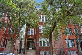 Chicago apartment for rent - a red brick apartment building with trees in front of it