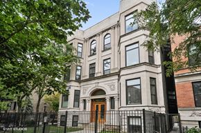 Chicago apartment for rent - the apartment building has a brown door and a white facade