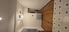 Chicago apartment for rent - A bathroom with a shower and a wooden wall.