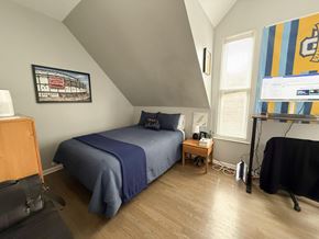 Chicago apartment for rent - A bedroom with a bed, nightstand, and a painting on the wall.