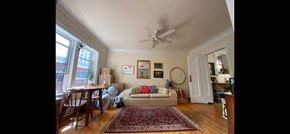 Chicago apartment for rent - A living room with a couch, chairs, and a rug.