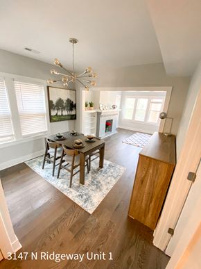 Chicago apartment for rent - A dining room with a table set for six and a chandelier hanging from the ceiling.