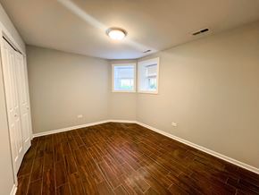 Chicago apartment for rent - A room with wooden flooring and a window.