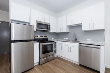 Denver apartment for rent - A kitchen with white cabinets and stainless steel appliances.