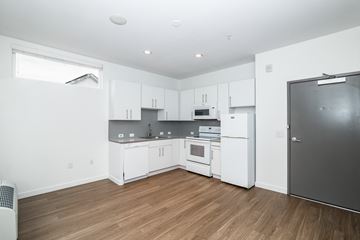 Denver apartment for rent - A kitchen with white cabinets and a refrigerator.