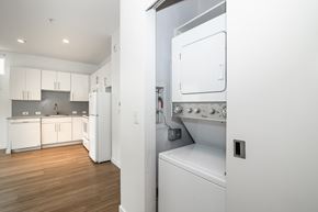 Denver apartment for rent - A white kitchen with a refrigerator and oven.