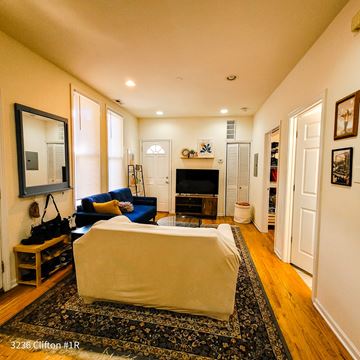 Chicago apartment for rent - A living room with a white couch and a fireplace.