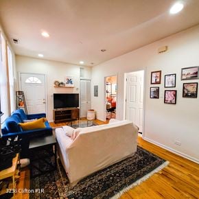 Chicago apartment for rent - A living room with a couch, a chair, a coffee table, a fireplace, and pictures on the wall.