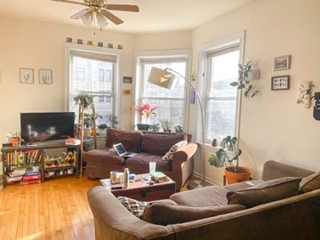 Chicago apartment for rent - A living room with a brown couch and a television.